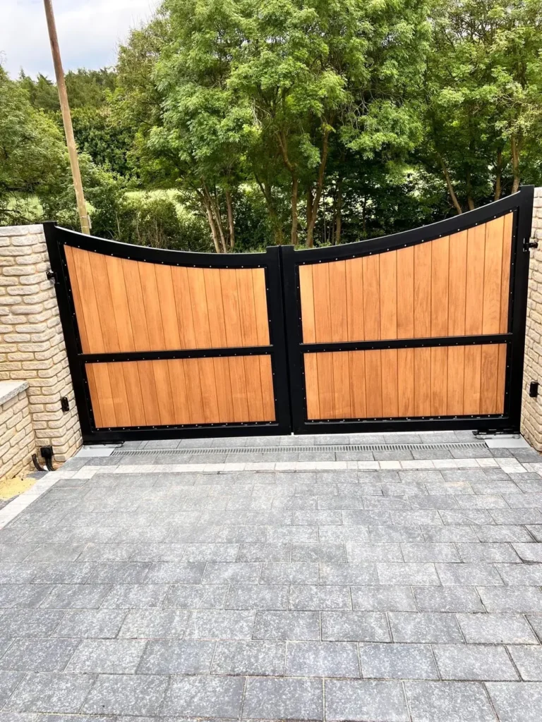 Bespoke timber and steel automated double driveway gates on a block-paved private drive, made and installed by Mr Gates