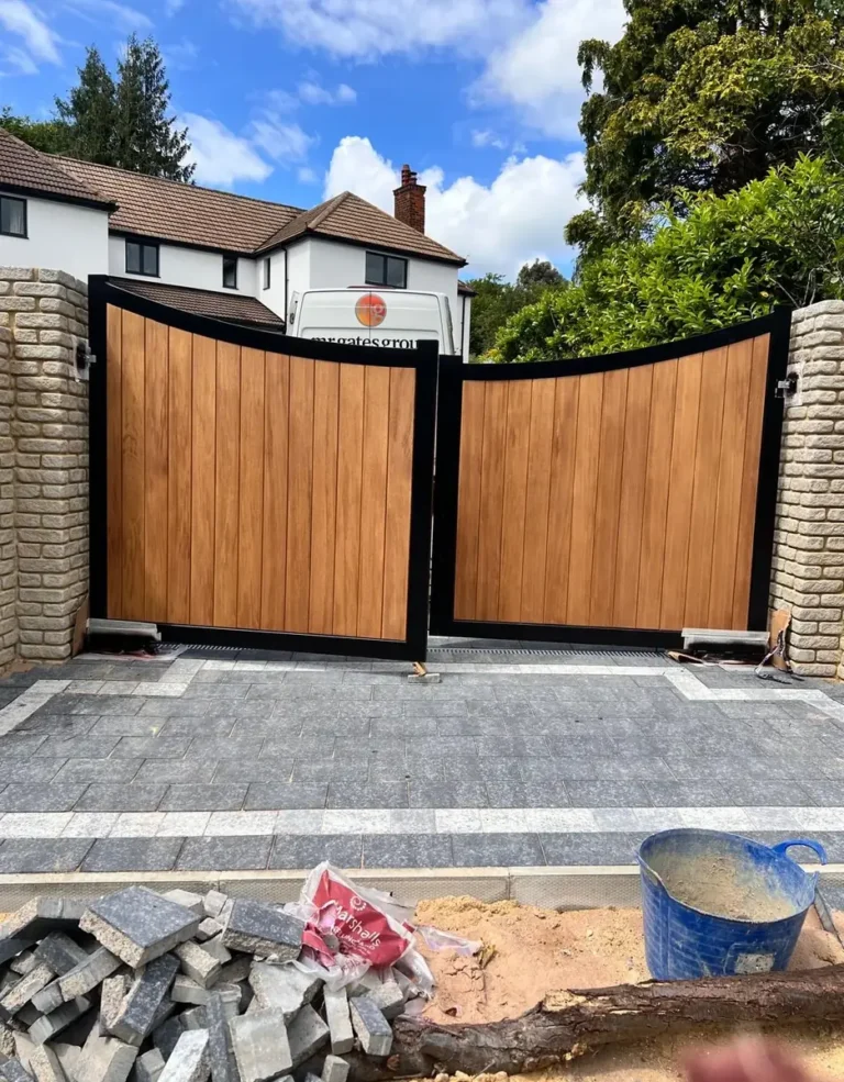 Automated timber-infill double driveway gates fitted to a private home