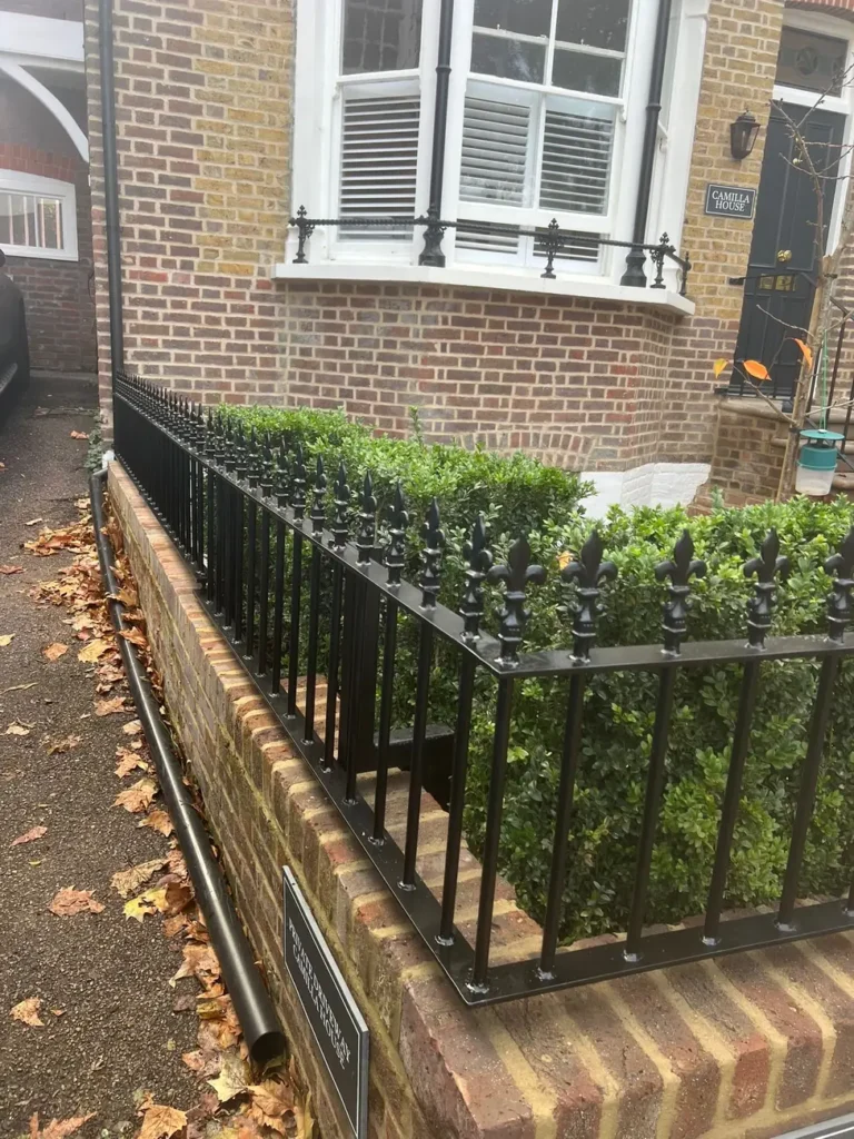 Black metal railings to a period property front garden