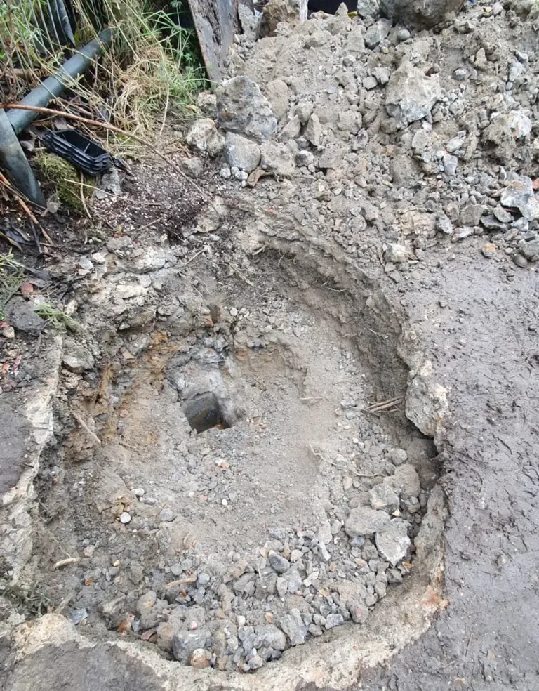 A bollard being installed into a concreted ground socket