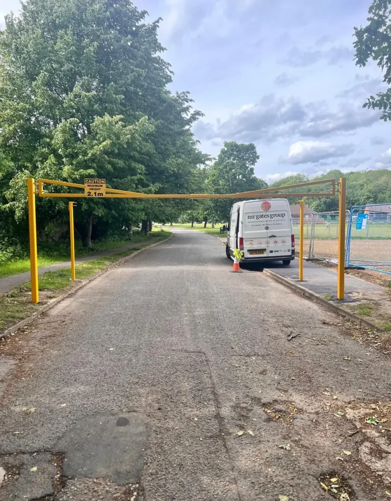 A Mr Gates van beside a newly installed car park height restriction barrier