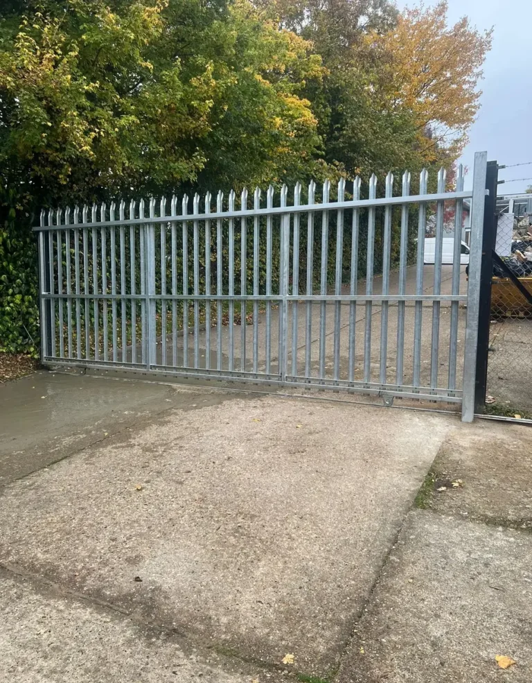 A galvanised palisade sliding gate securing a commercial yard entrance