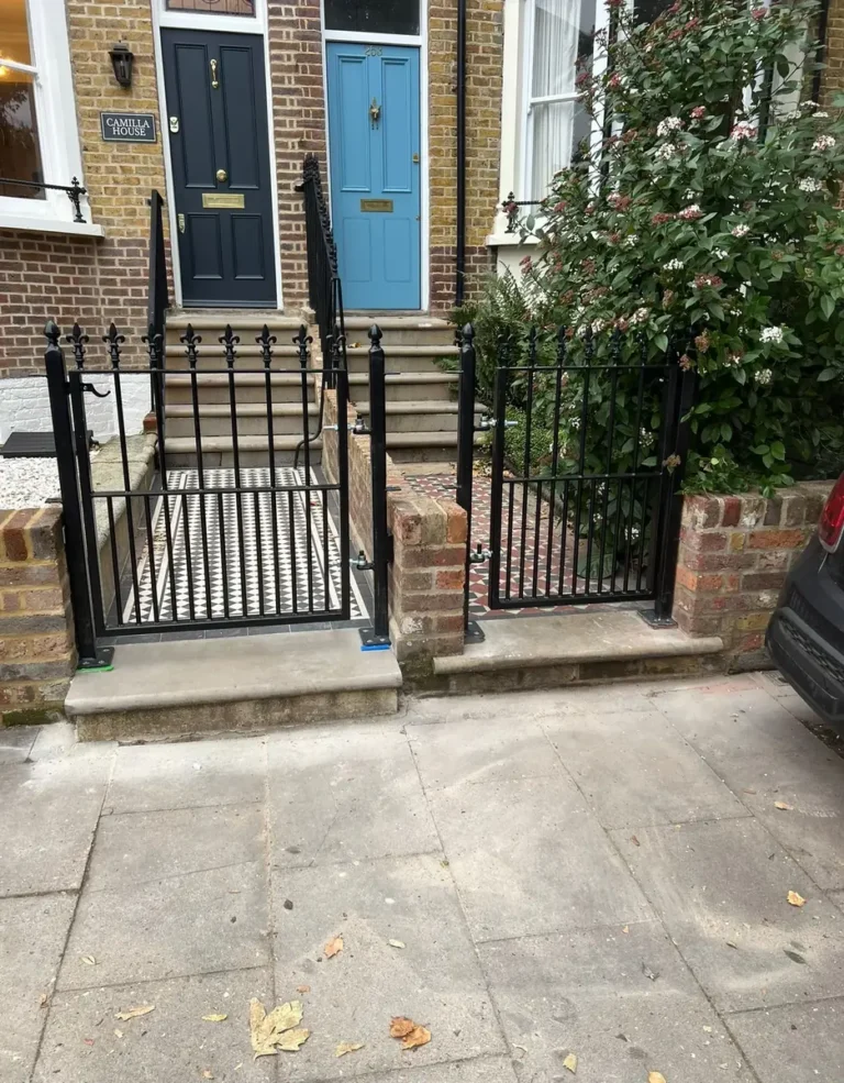 Metal railings and a matching gate to the steps at a front door