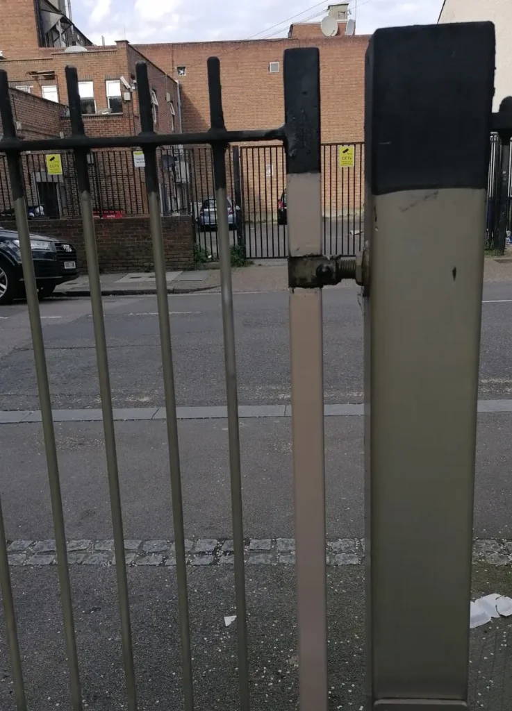 A gate automation actuator installed on a metal gate