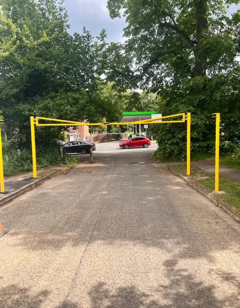 A yellow height restriction barrier at a car park entrance