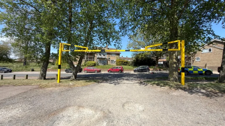 A height restriction barrier across a park car park