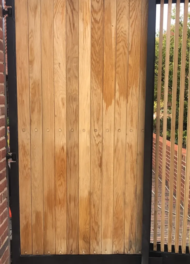 An oak timber-clad side gate in a steel frame, made in the Mr Gates workshop
