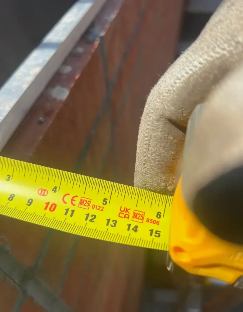 A Mr Gates engineer taking measurements on site during a survey