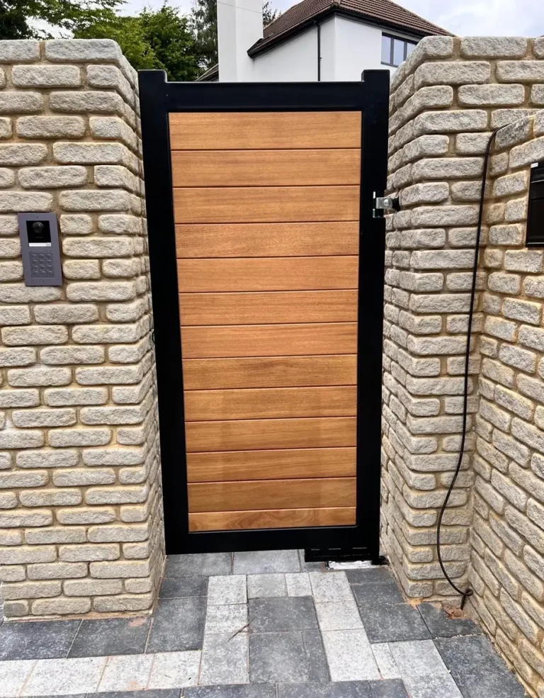 A timber pedestrian gate set into a stone pier with keyless entry