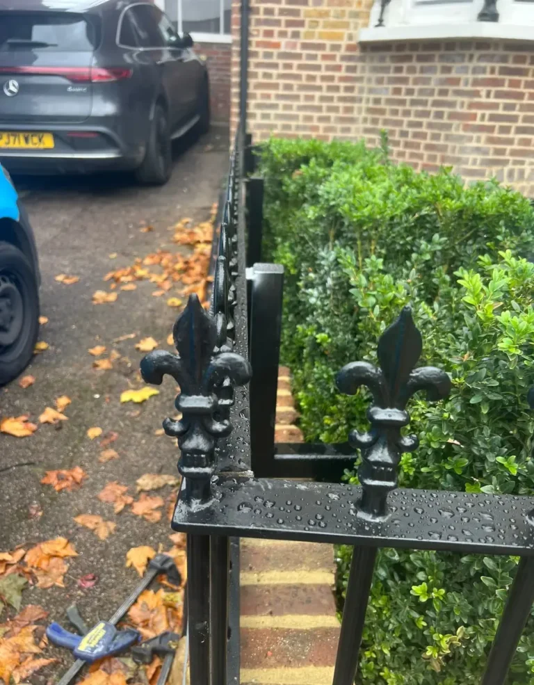 A cast finial detail on traditional wrought-effect railings