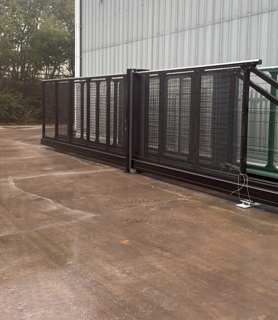 Black cantilever sliding gate with mesh infill panels