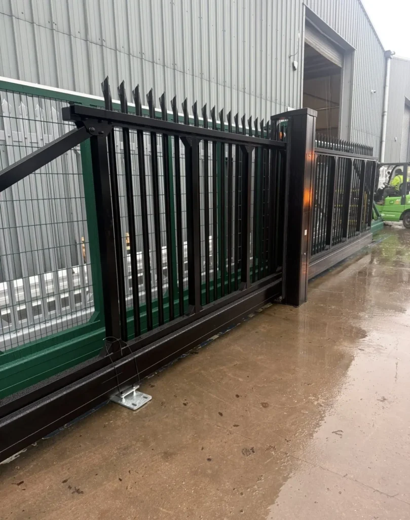 Black cantilever sliding gate with palisade infill and anti-climb spikes